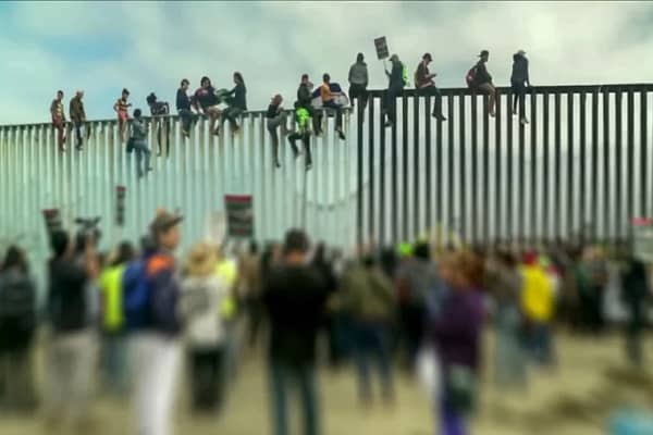 Challenges of Illegal Immigration: A Balanced Perspective Illegal Immigrants climbing border wall